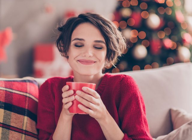 happy woman holidays coffee on couch