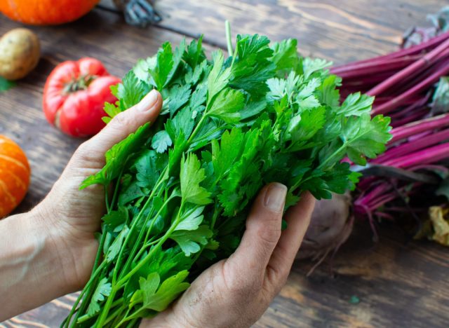 holding fresh parsley