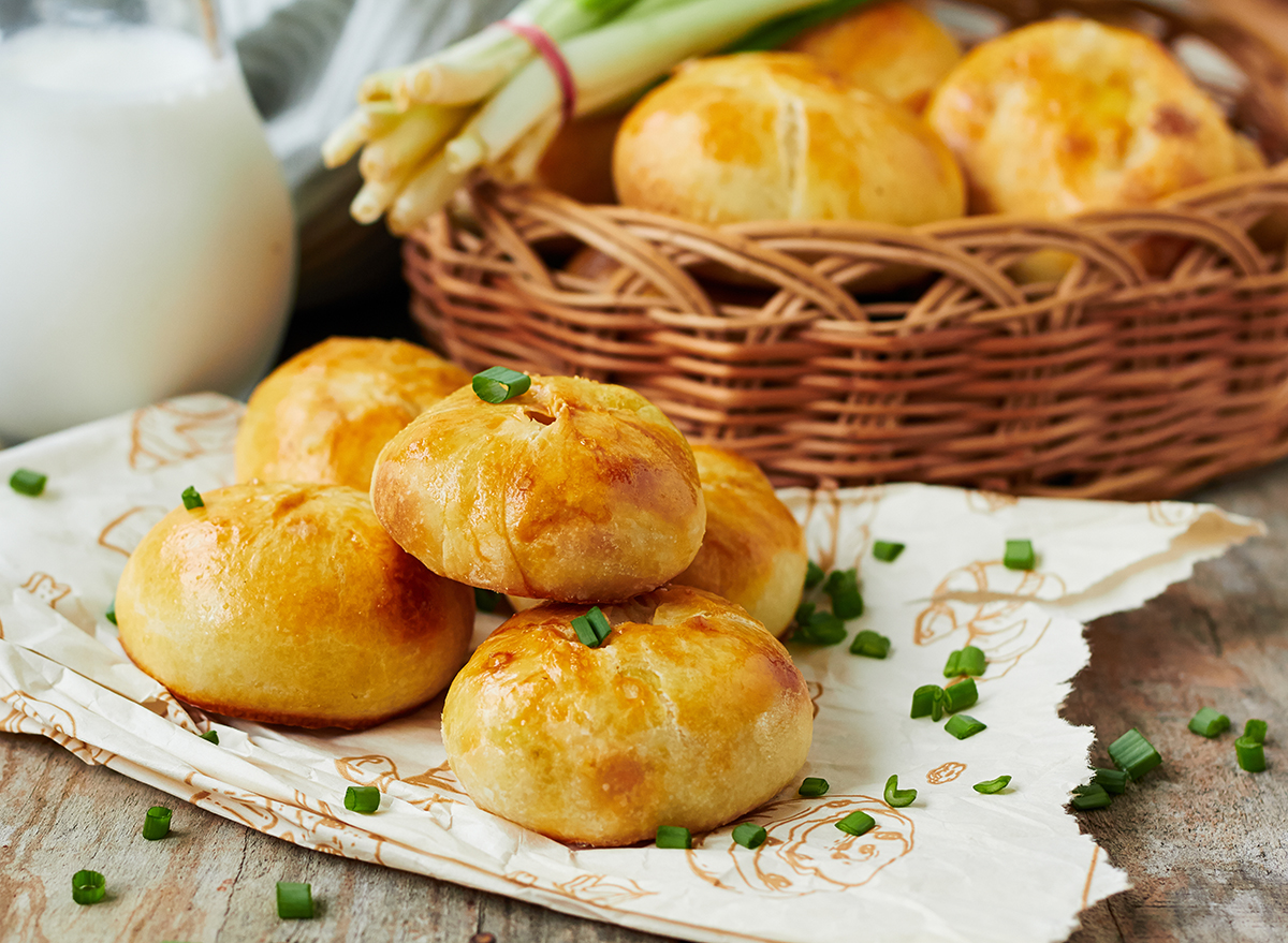 knishes stacked on a wooden surface