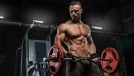 muscular man lifting barbell, concept of strength workouts for men to get shredded